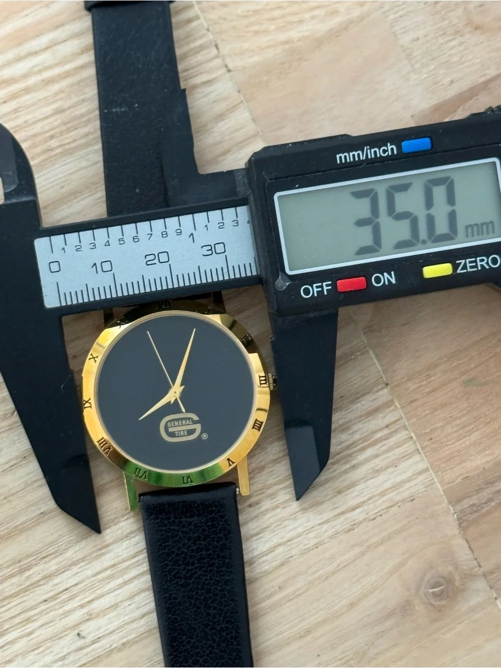 General Tire Dress Watch Black Dial Leather Strap Gold-Tone Case Hands